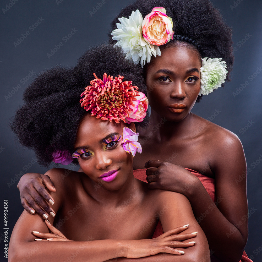 Change is beautiful. Cropped shot of two beautiful women posing together with flowers in their hair.