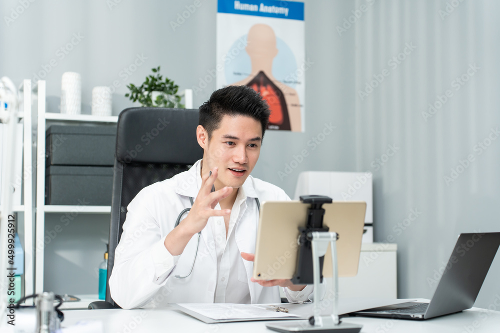 Asian male medical doctor talking virtual online with patient at home. 