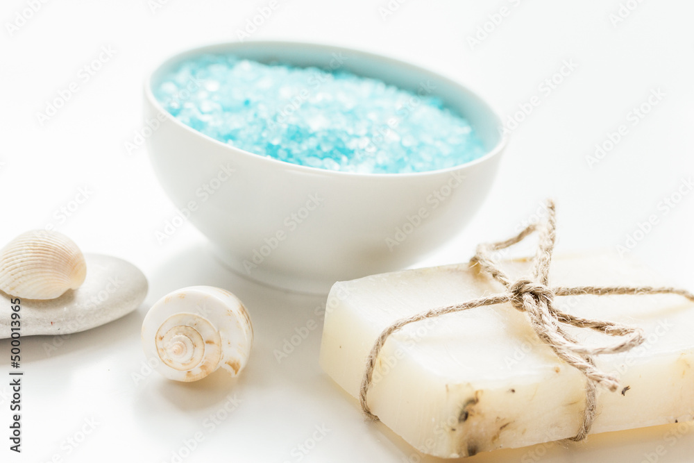 spa composition with blue sea salt and natural soap on white desk background