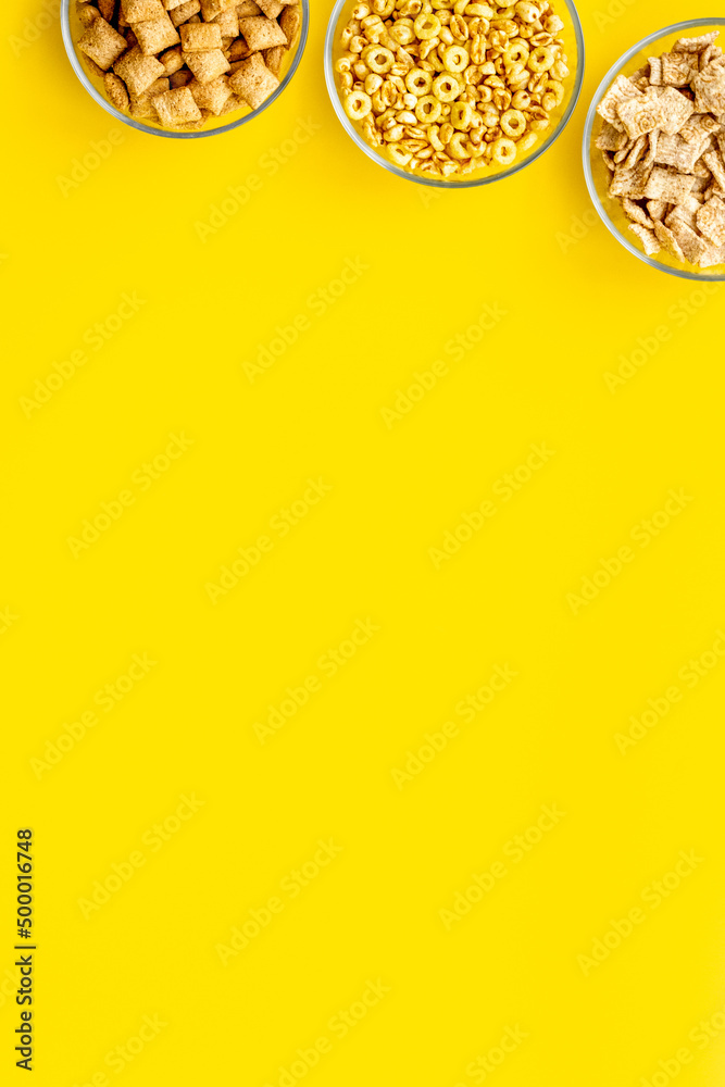 Cereals and flakes from corn and oat on yellow background top view mockup