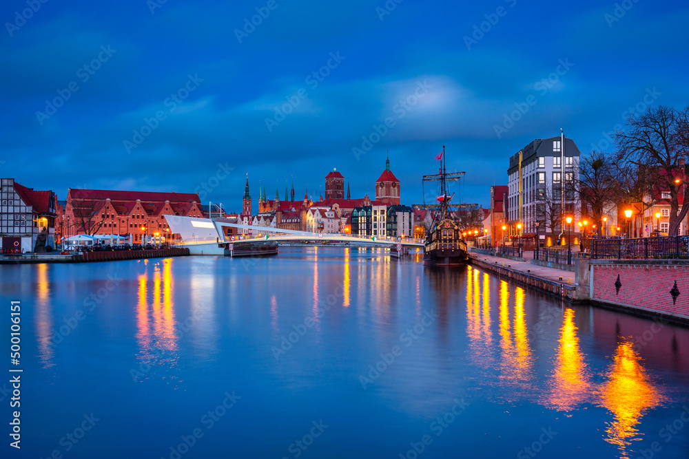 Beautiful architecture of Gdansk old town reflected in the Motlawa river at dawn, Poland