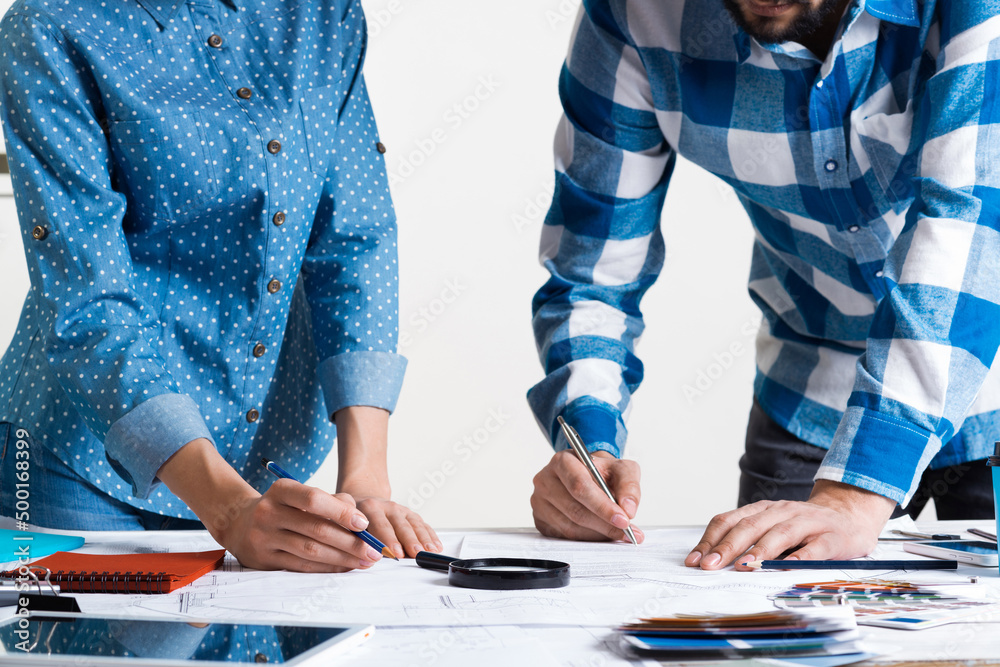 Man carefully studying technical drawing