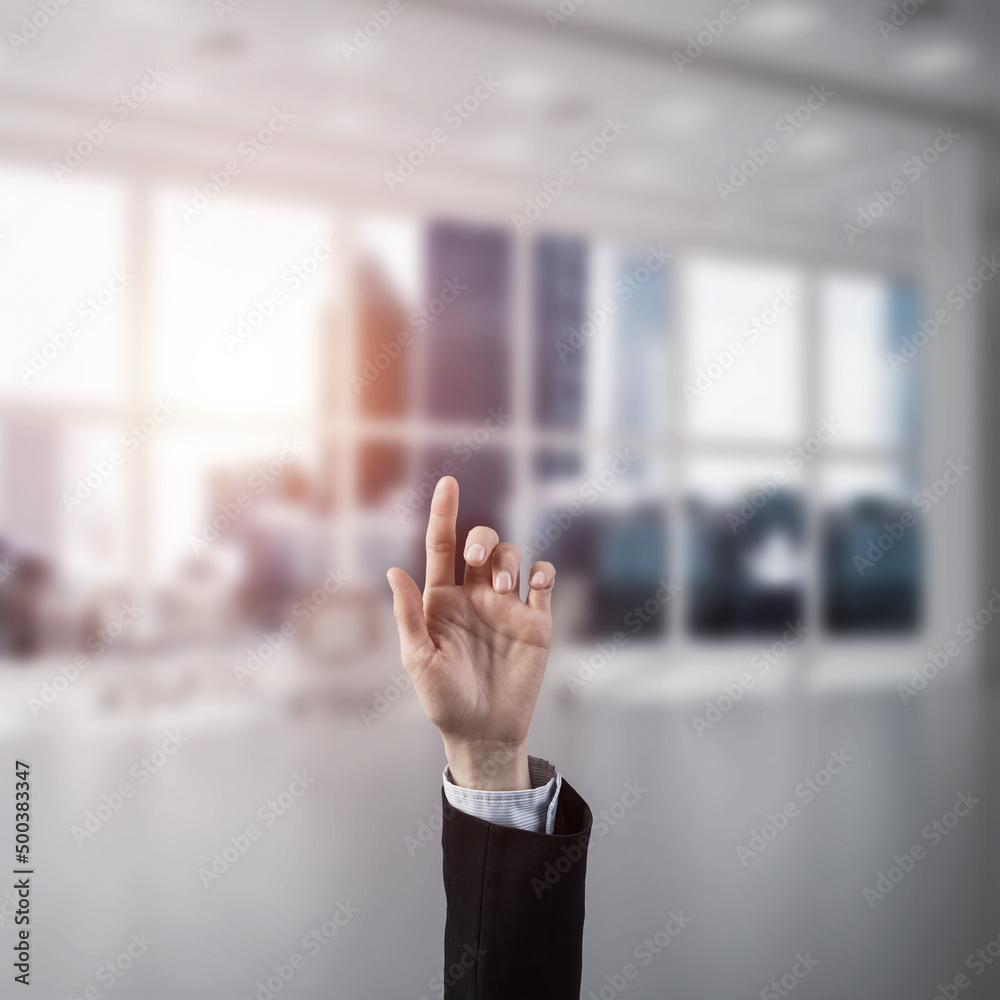 Choosing gesture of businessperson in elegant modern interior in sunshine light