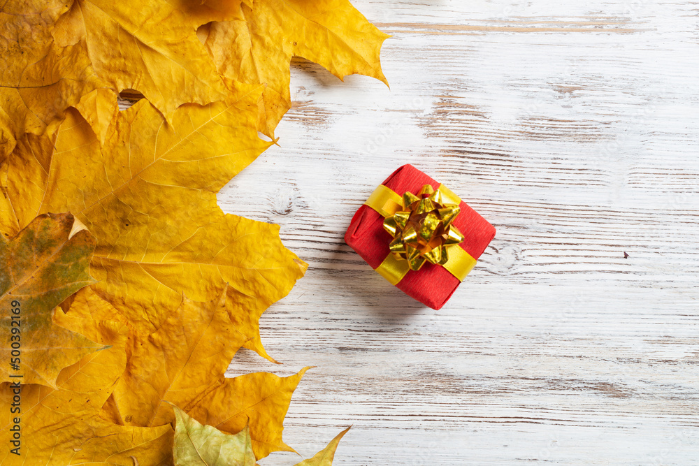 Bright autumn composition with gift box