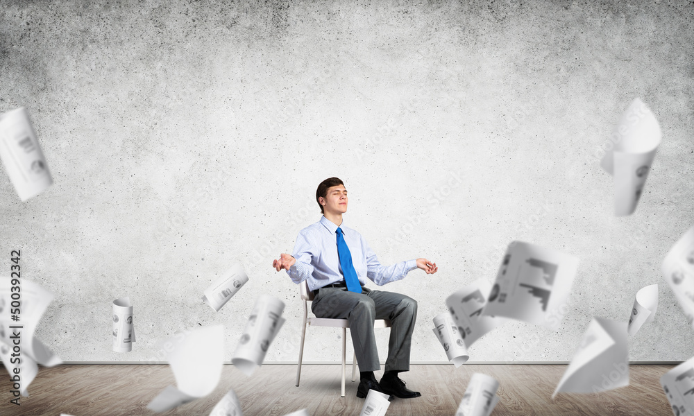 businessman meditates on office chair