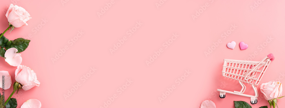 Mothers Day shopping design concept background with pink rose flower and cart on pink background.