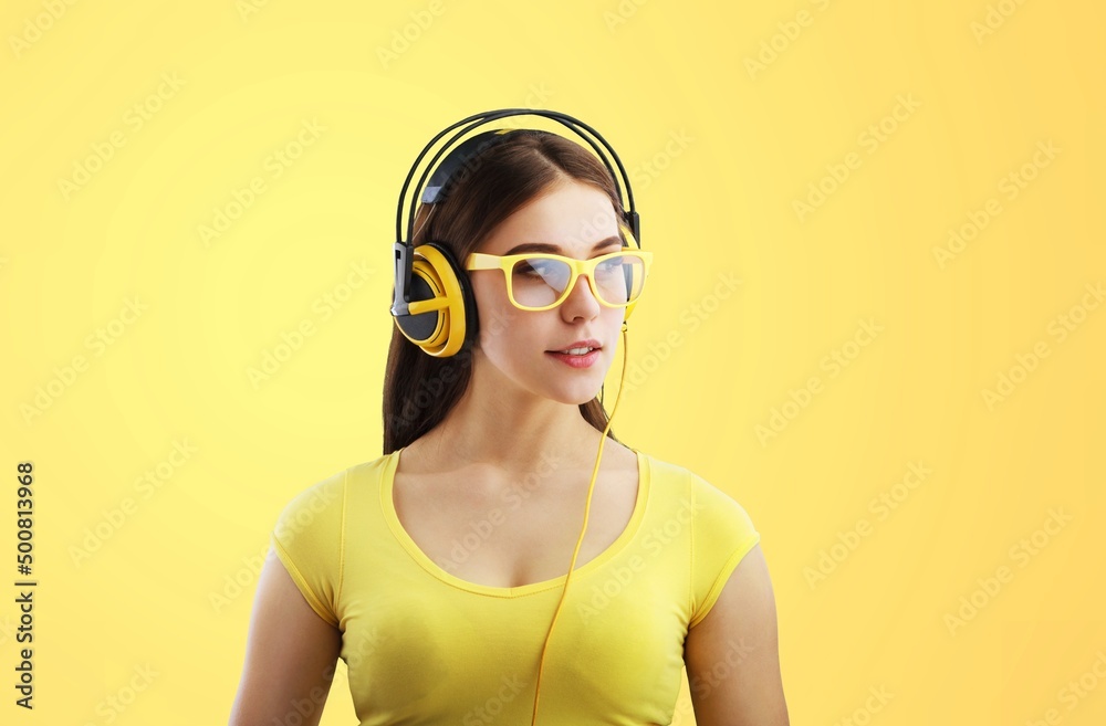 Happy lady with headphones listening to music and dancing, cool playlist and moving concept.