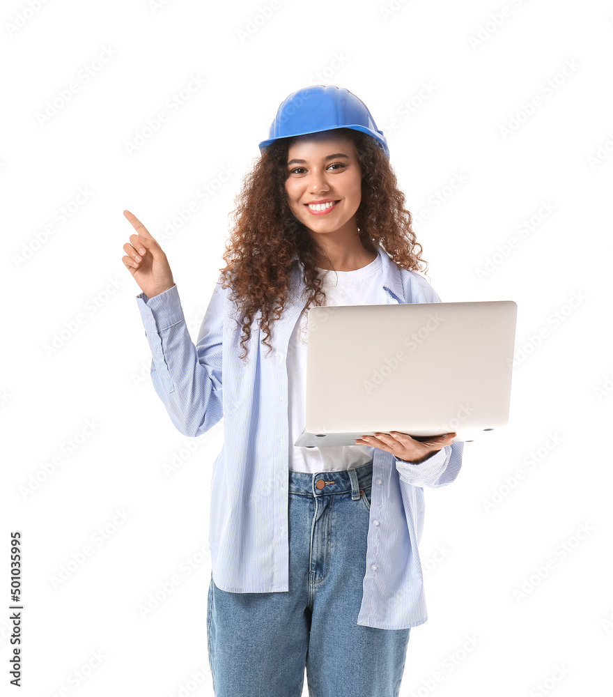 Young female designer with laptop showing something on white background