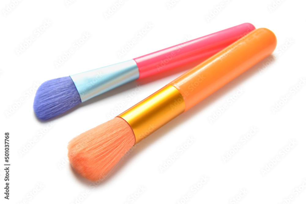 Colorful makeup brushes on white background