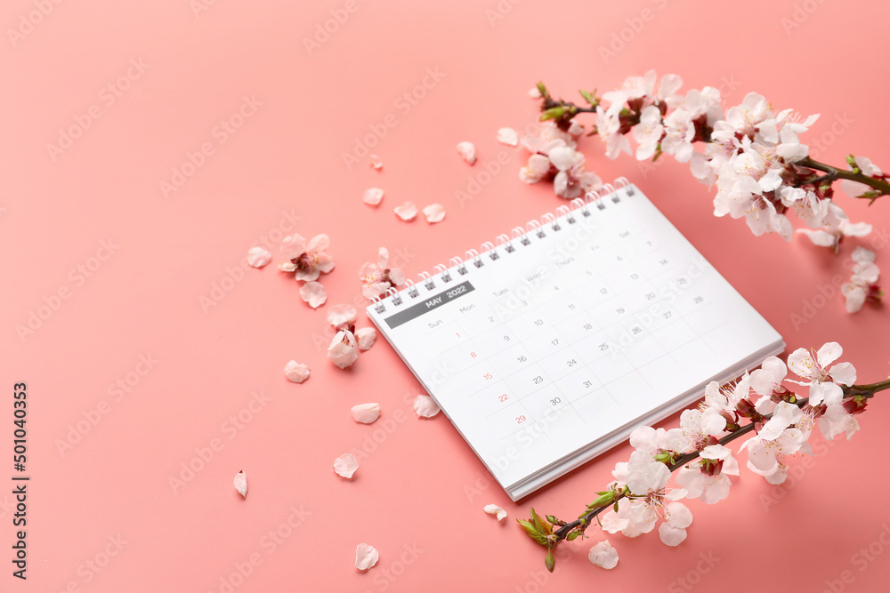 Beautiful blooming spring branches and calendar on pink background