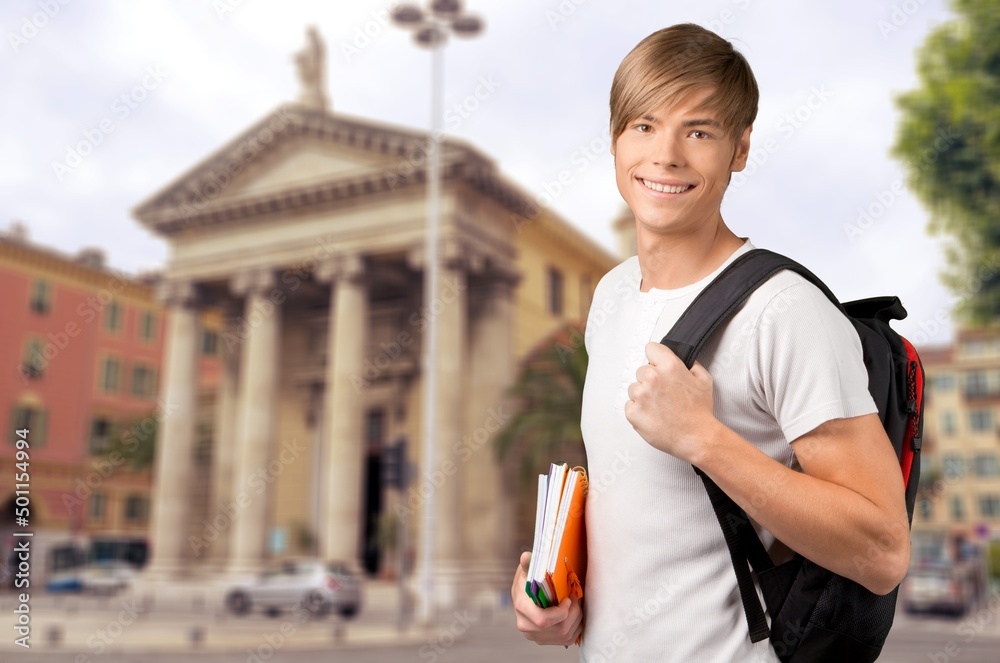 Happy young student at the university background