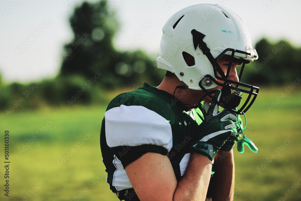 American football player putting on a helmet