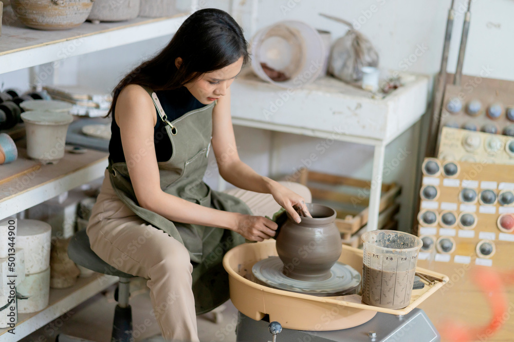 在陶轮上工作的女性双手特写，亚洲女性雕塑女性塑造模具小va