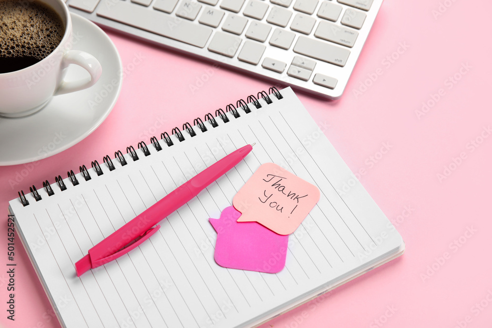 Sticky notes with text THANK YOU, notebook and pen on pink background, closeup