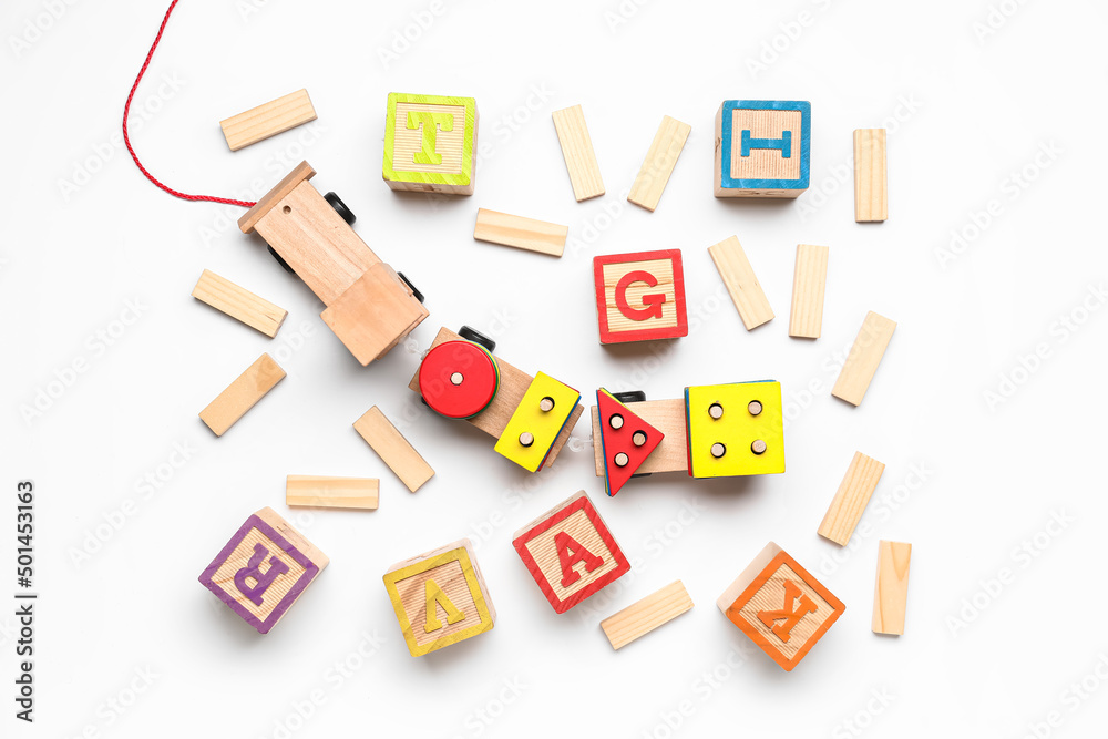 Wooden cubes with letters and blocks on white background