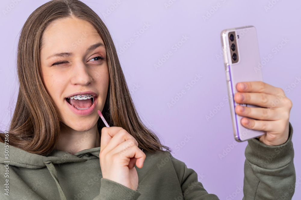 Close up portrait of young girl make selfie by cellphone.