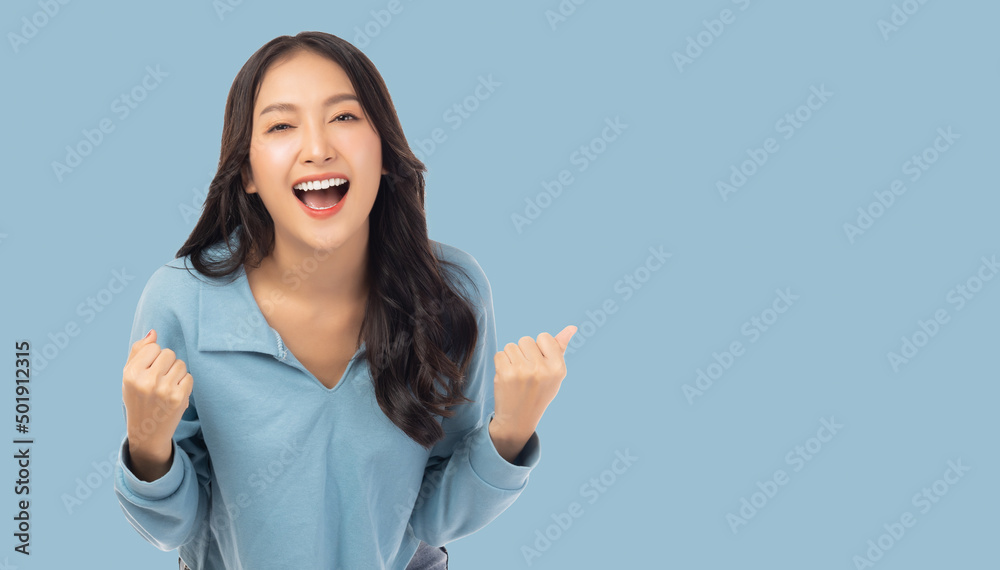 Excited young asian woman with raised hand celebrating success Portrait cheerful positive asian fema