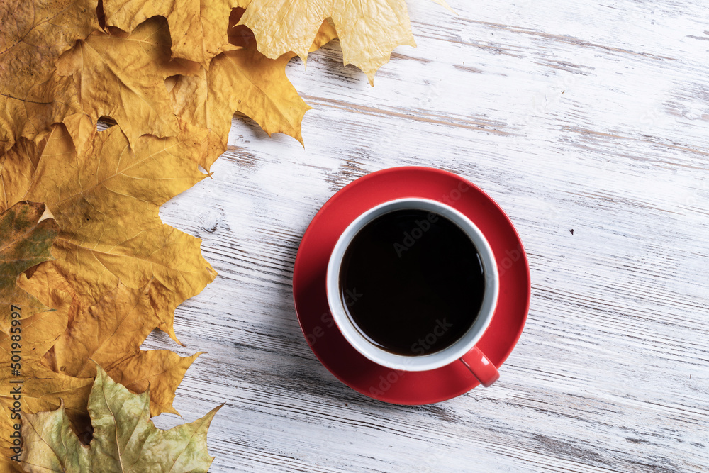 Flat lay autumn composition with cup of black tea