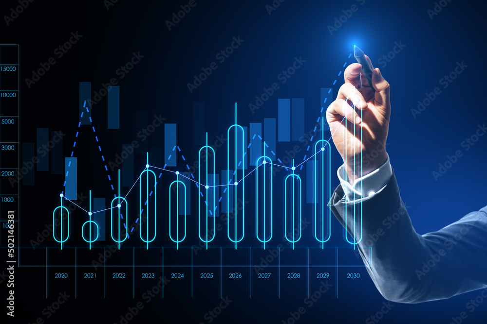 Close up of businessman hand pointing at growing annual business chart report on blurry background. 