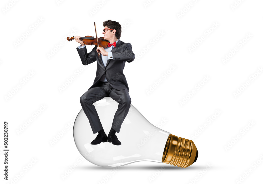 A young businessman sits on a light bulb