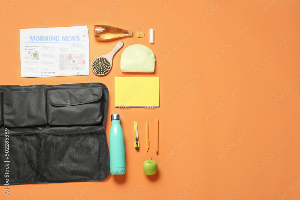 Travel organizer and different things, bottles of drink and apple on color background