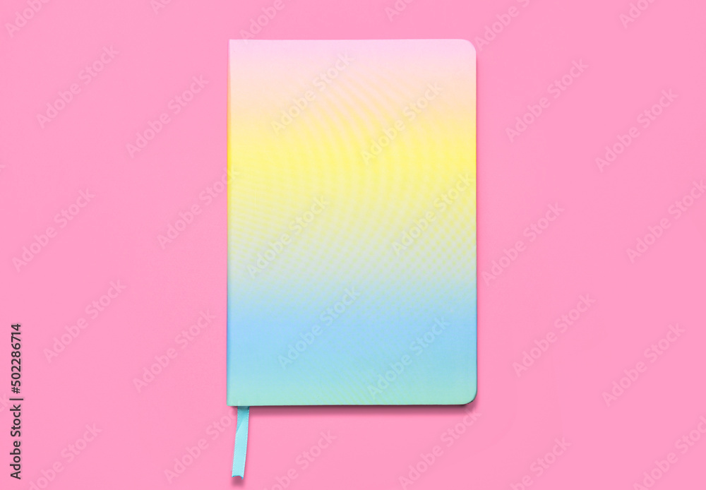 Colorful notebook on pink background