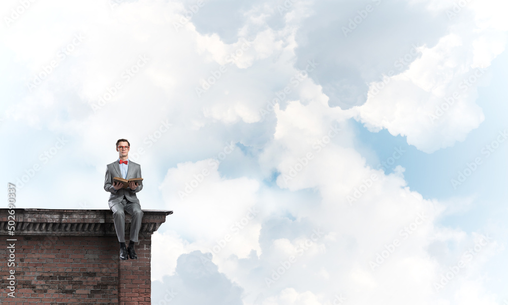 Young businessman or student studying the science on building roof