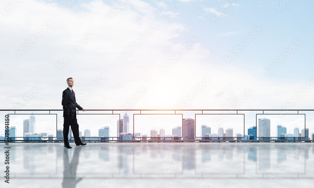 Sunrise above skyscrapers and businessman facing new day