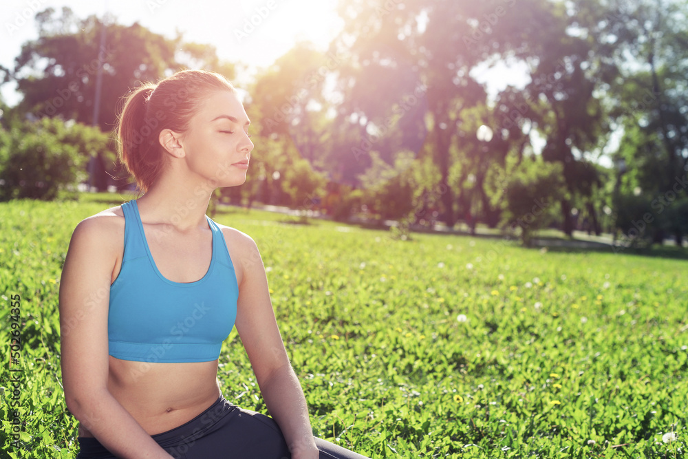 Beautiful smiling girl in sportswear relax in park