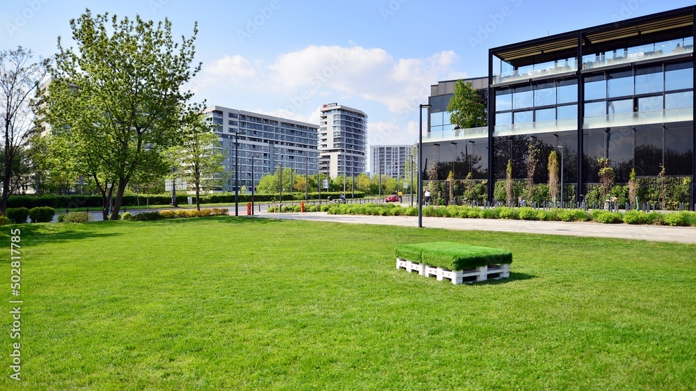 People and area in the sun next to  shopping center. 