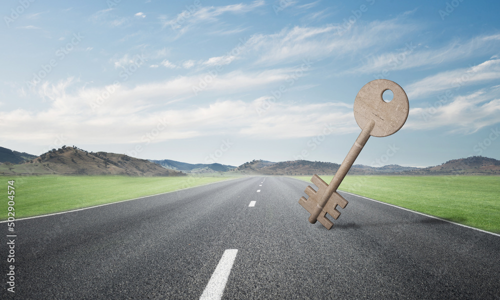 Conceptual background image of concrete key sign on asphalt road