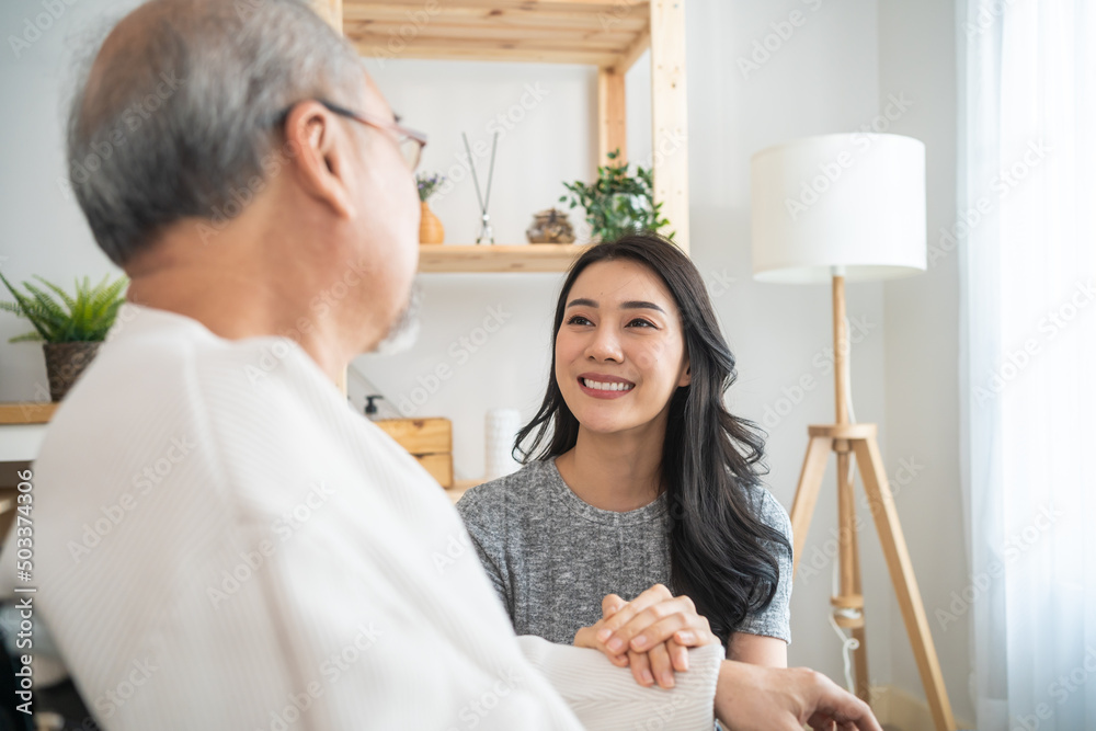 亚洲女儿支持家里坐在轮椅上的残疾老人。