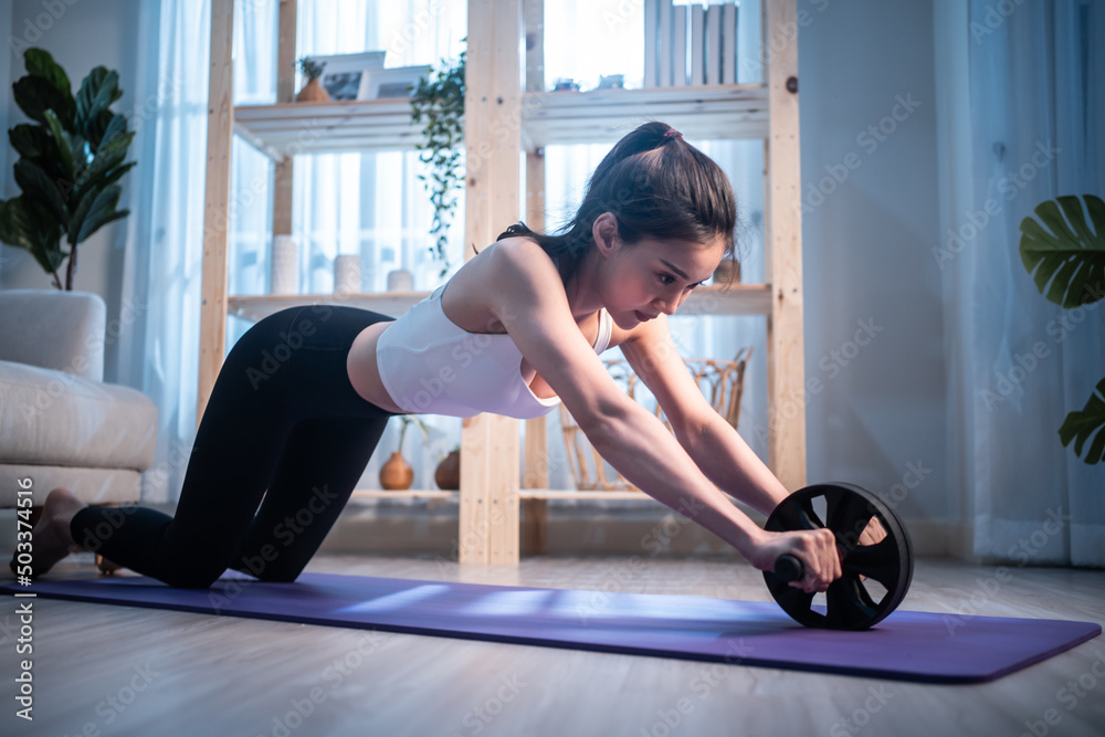 Asian young beautiful active sport woman doing cardio workout at home. 