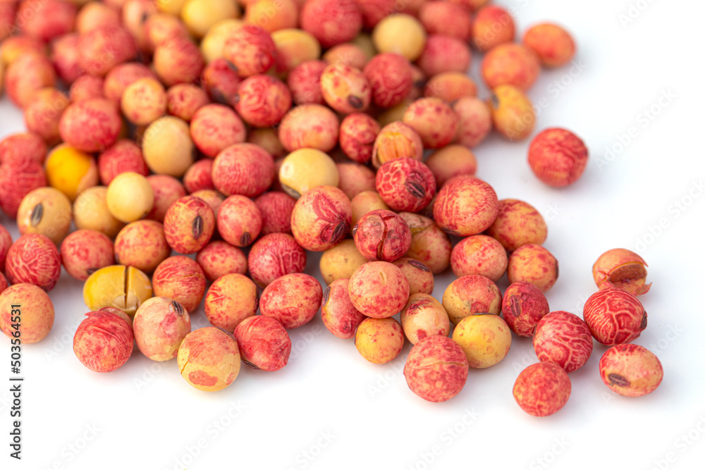 Soybean seeds treated with protective drugs on a white background.