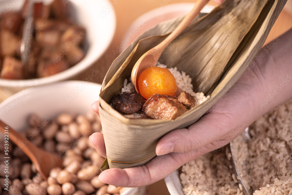 Making zongzi food - preparing and wrapping Chinese rice dumpling.