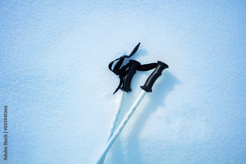 Mountain ski poles pair in the snow from above close-up image