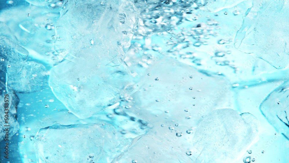 Close up of ice cubes underwater, blue background.