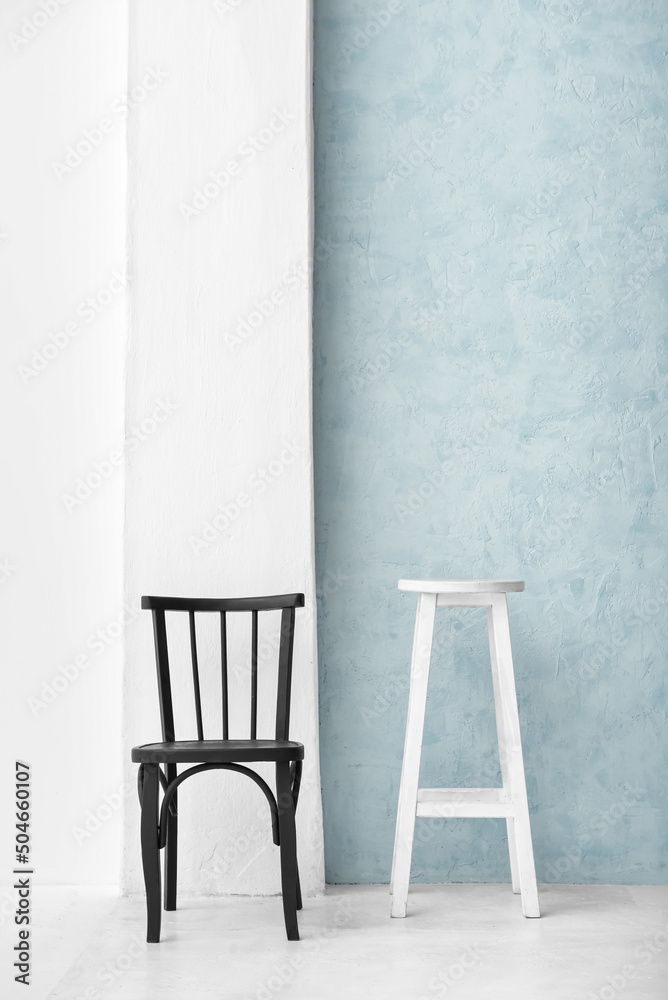 Black chair and white table in light room