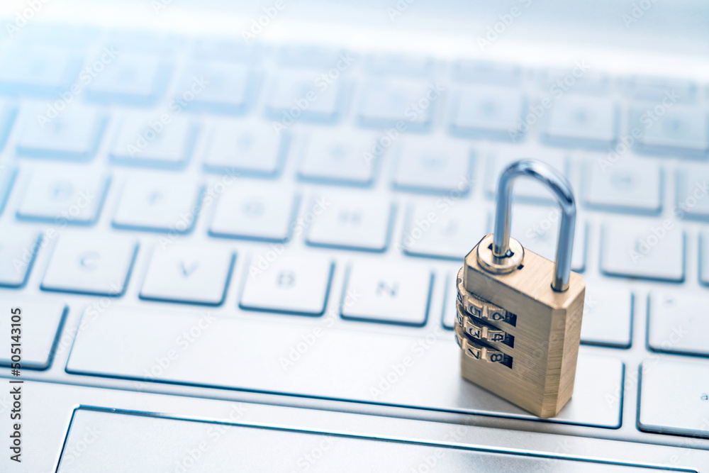 The lock is placed on the computer keyboard to symbolize information security and data interconnecti