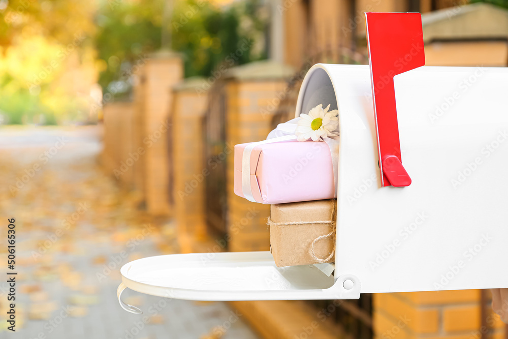 Vintage mailbox with gifts outdoors