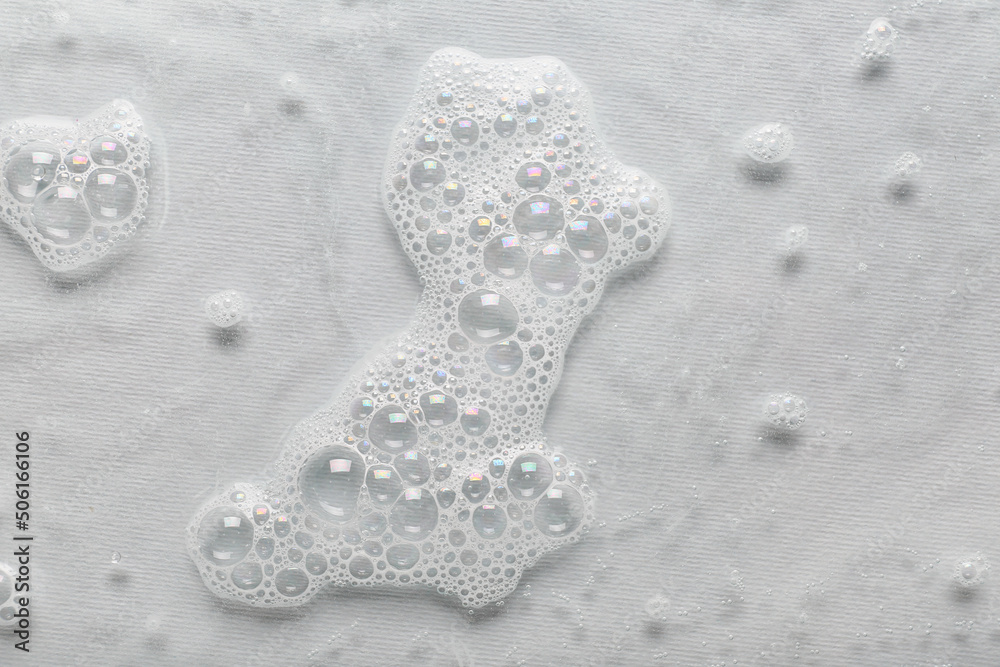 Water with soap foam on grey background