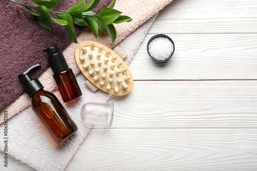 Set of bath supplies with vacuum jar for anti-cellulite massage on white wooden background