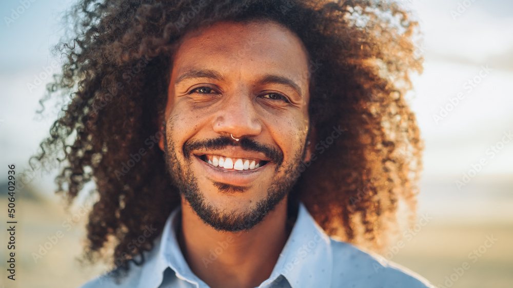 Portrait of a Happy Young Adult Male with Afro Hair and Nose Ring Piercing Posing for Camera. Handso