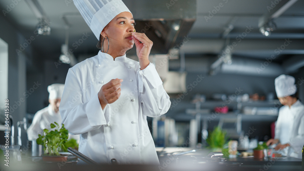 Restaurant Kitchen: Black Female Chef Fries Organic Patty on a Pan, Seasons it and Flips Cutlet with