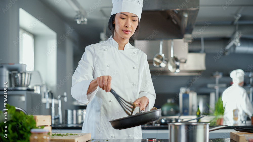 Restaurant Kitchen: Portrait of Asian Female Chef Stirs Her Favourite most Flavourful Dish, Smiles. 