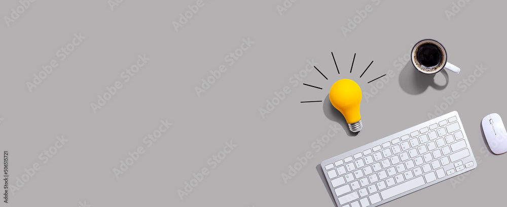 Computer keyboard with a yellow light bulb from above