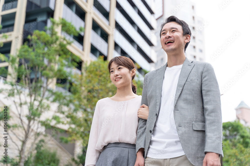 タワマンの前に立つカップルのポートレート