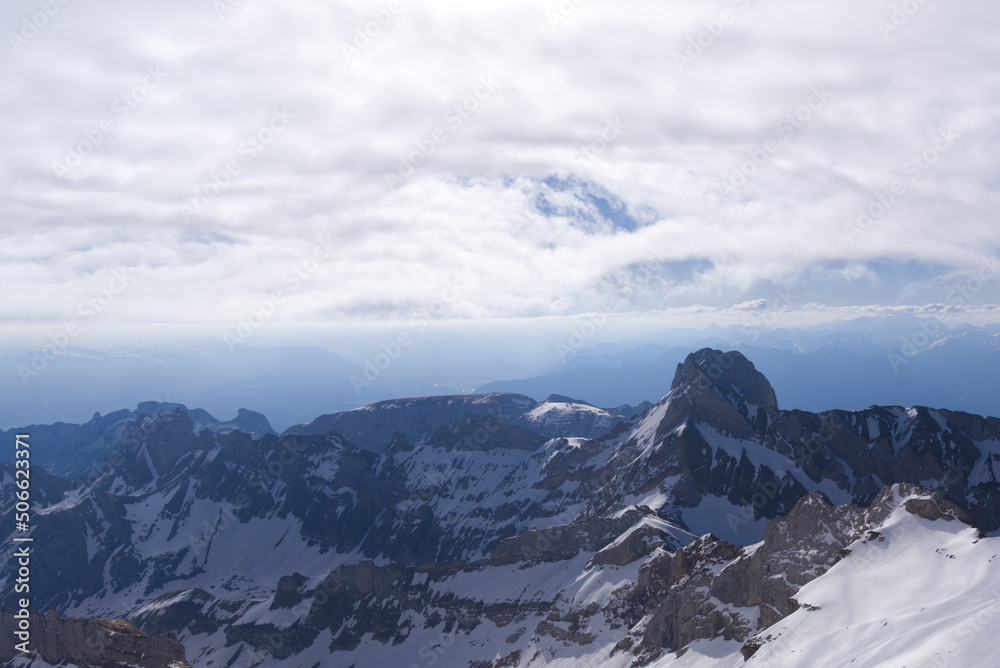 Aerial view over the Swiss Alps seen from Säntis peak at Alpstein Mountains on a sunny spring day. P