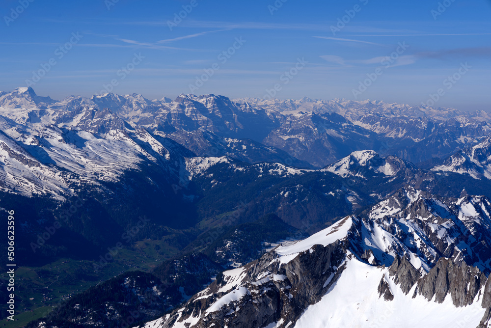 Aerial view over the Swiss Alps seen from Säntis peak at Alpstein Mountains on a sunny spring day. P