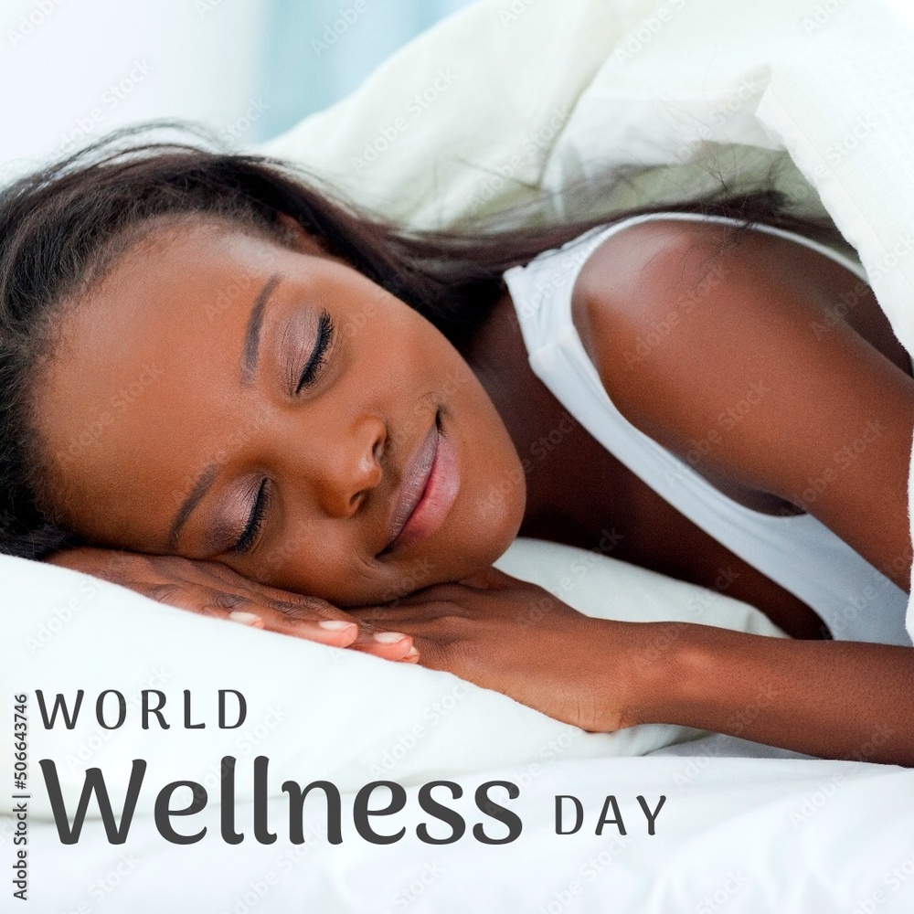 Digital composite image of wellness day text over young african american woman sleeping on bed